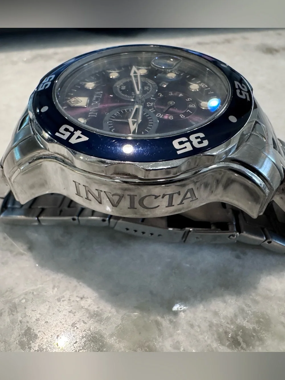 Invicta Silver Stainless Steel Watch with Black Bezel and Dark Dial